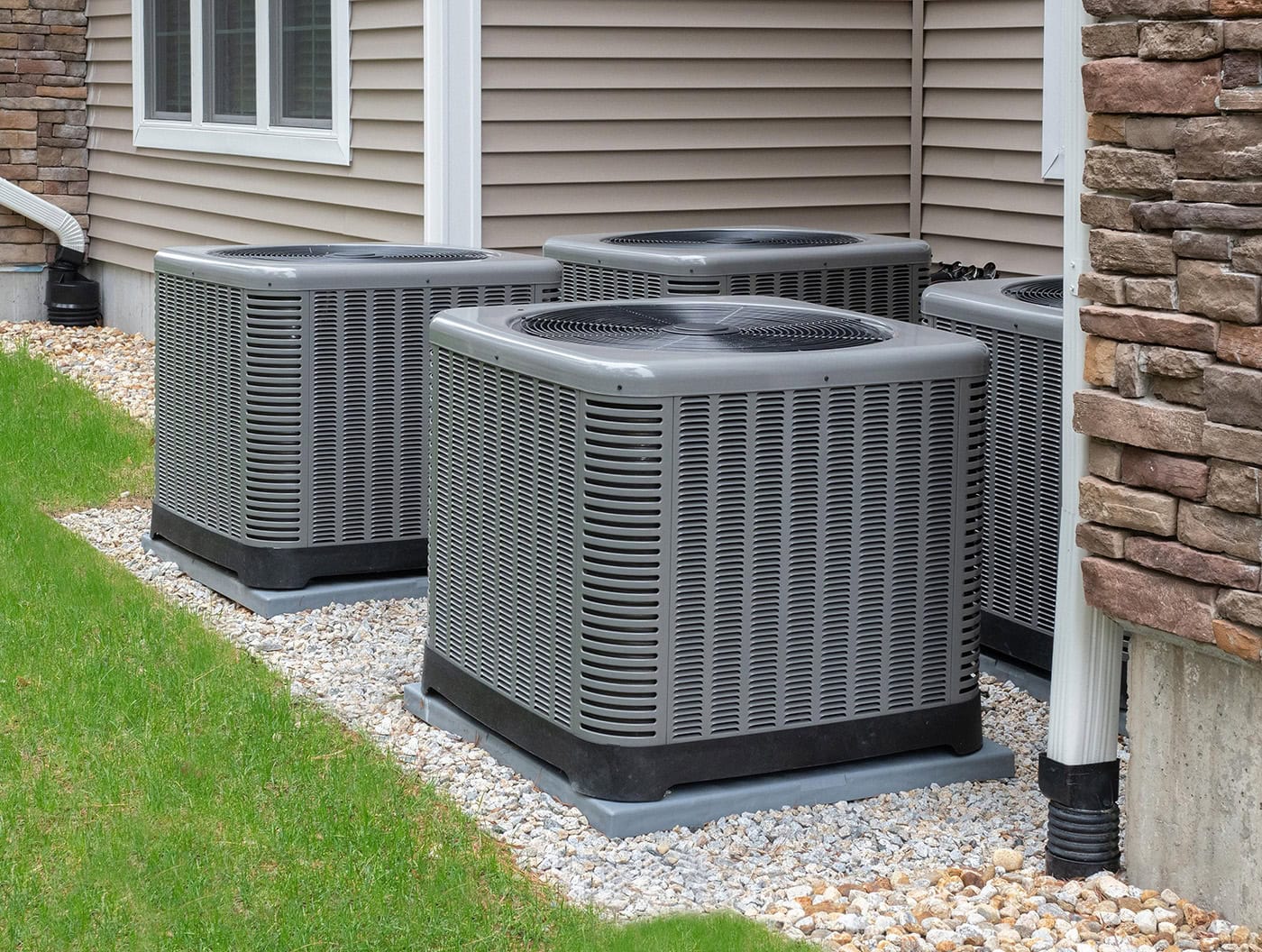 Armor Heating and Air AC units outside a residential home for heating and air conditioning systems.